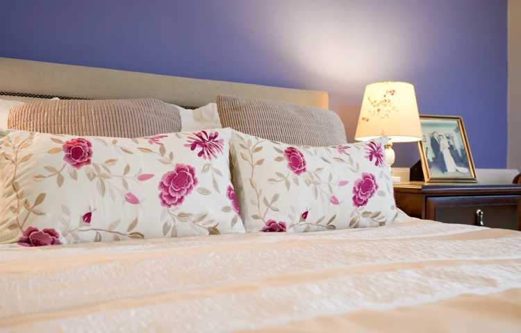 A peaceful bedroom at Westall House in Horsted Keynes with beautiful floral pillows