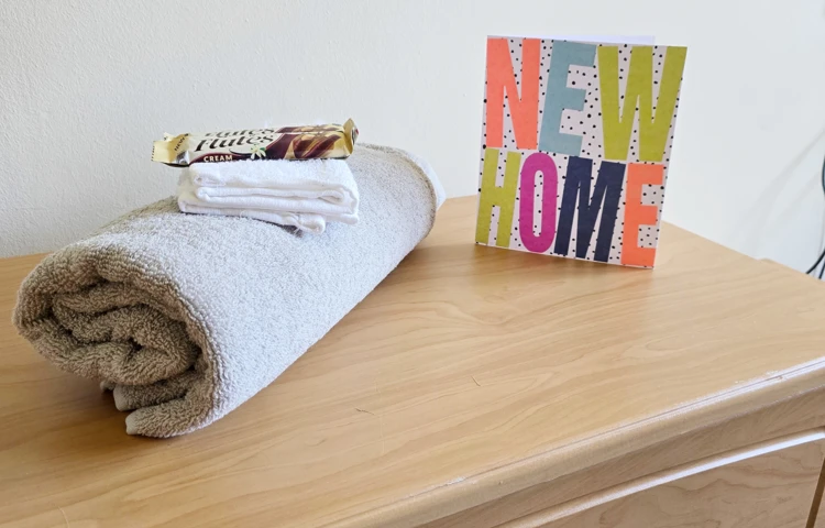Side Cabinet With Towel, Chocolate And New Home Card At Downing House