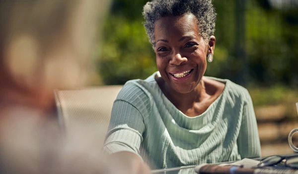 Smiling Older Woman Sitting In The Sunshine