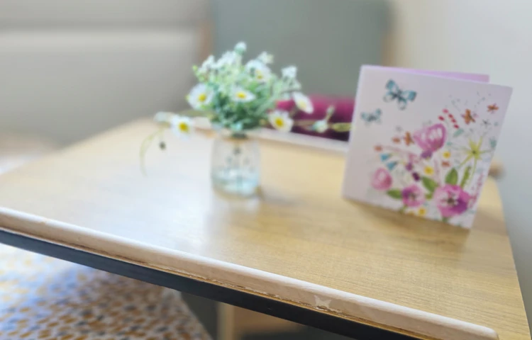 Card And Flowers On Over Bed Table In A Resident Room