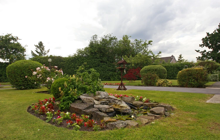 Flower beds in front garden at Abbeyfield House, Stockport SK6 8DU