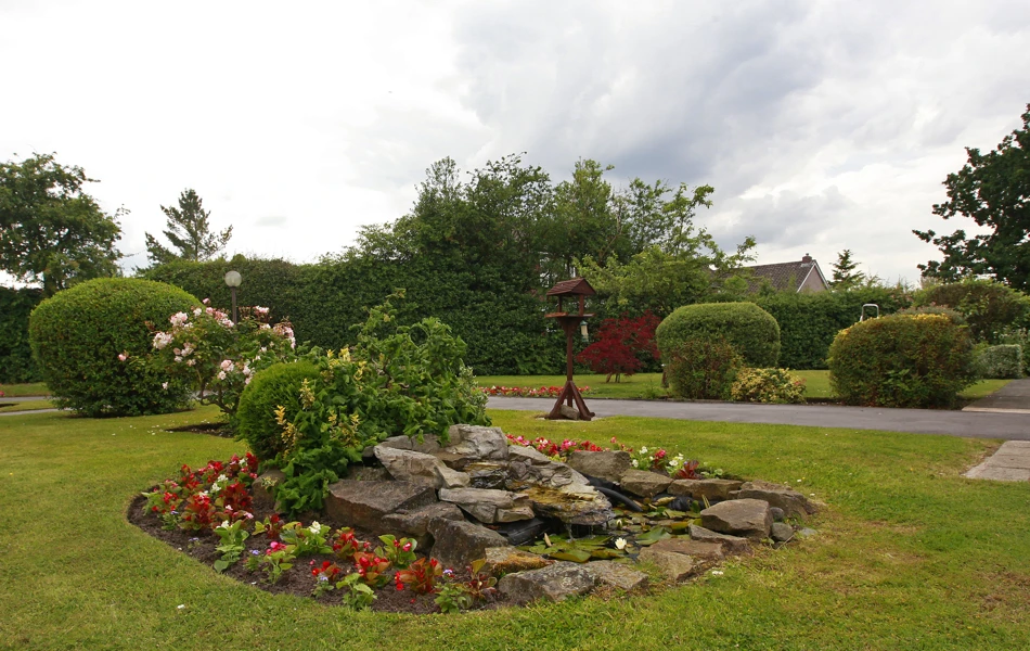 Flower beds in front garden at Abbeyfield House, Stockport SK6 8DU