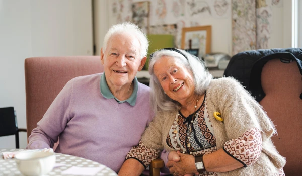 Older Couple Sitting Together With A Hot Drinks