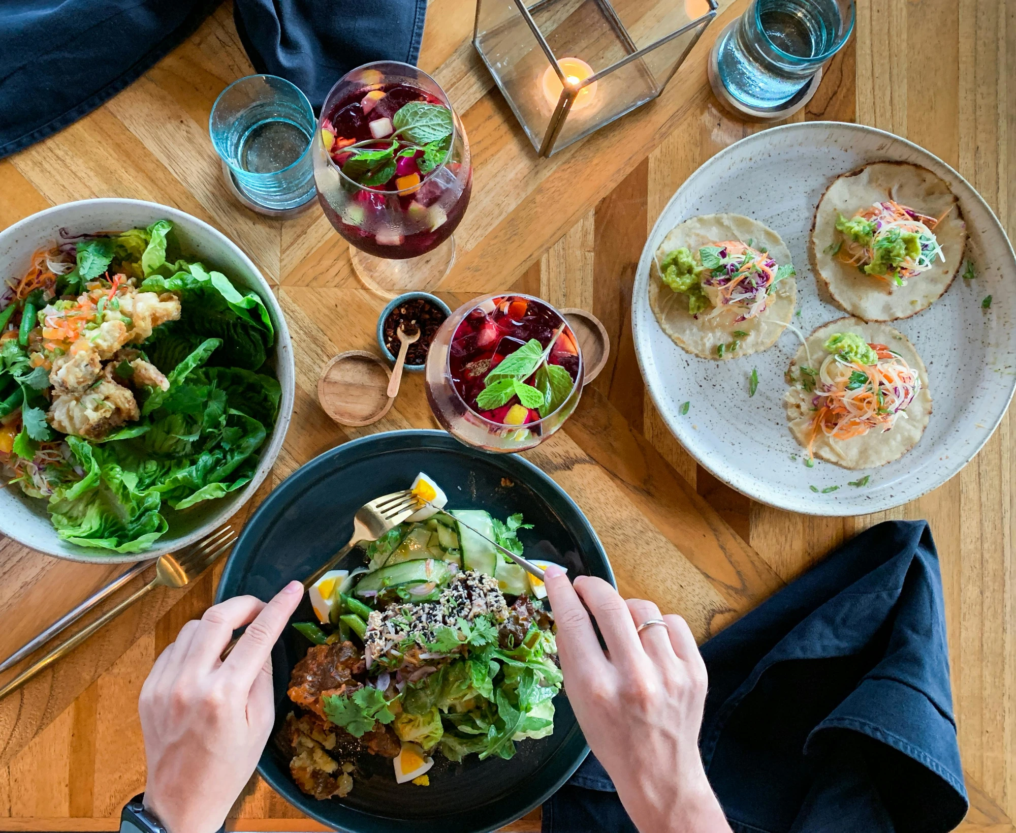 Overhead view of two people eating some healthy meals