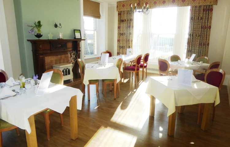 Residents dining area with tables set for dinner