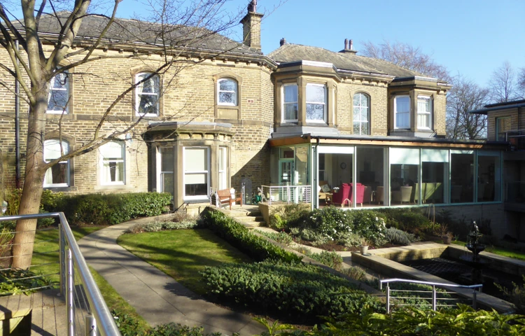View from outside Abbeyfield Ing Royd with its conservatory, garden and pond independent living in Halifax