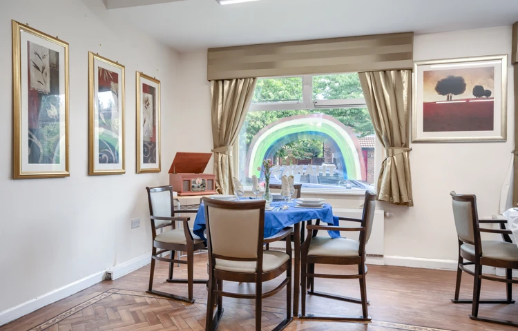 Residents dining room Downing House seating area with wall art