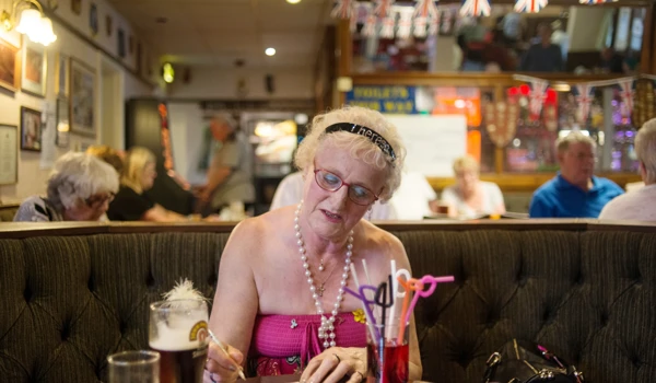 Older Woman Enjoying A Games Night At Pub