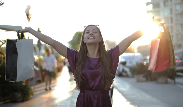 Woman Holding Shopping Bags Up In The Air