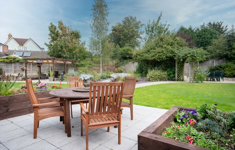 Garden patio area with tables and chairs at Hampton House Solihull