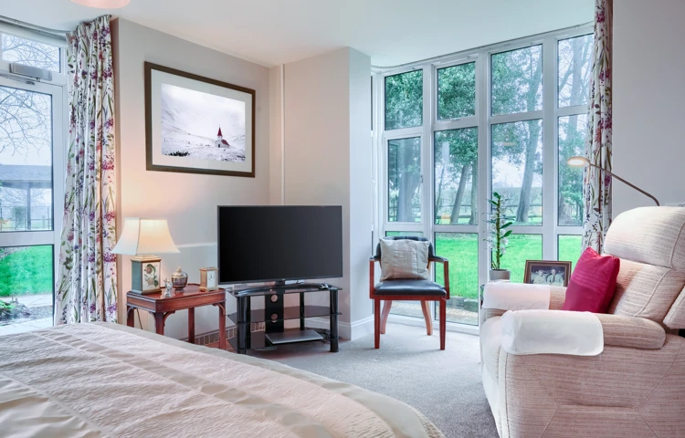 Comfortable armchair and television in a resident's room at Westall House Residential Care Home, Horsted Keynes, creating a relaxing and private space