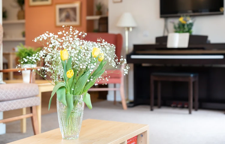 fresh-flowers-on-the-coffee-table-in-lounge at Abbeyfield House, Lincoln LN1 3HJ