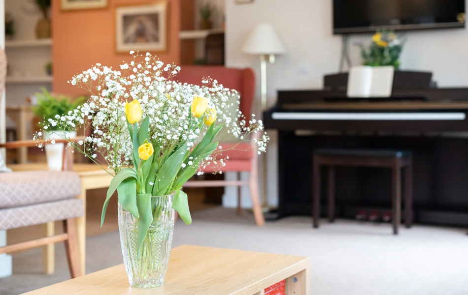 fresh-flowers-on-the-coffee-table-in-lounge at Abbeyfield House, Lincoln LN1 3HJ