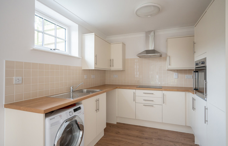 A kitchen with appliances and ample cupboard space