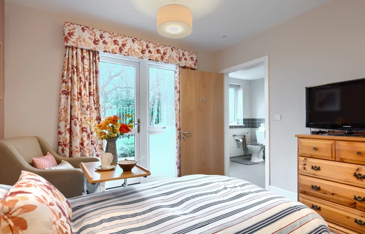 A bright and welcoming resident room at Westall House Dementia Care Home with en-suite