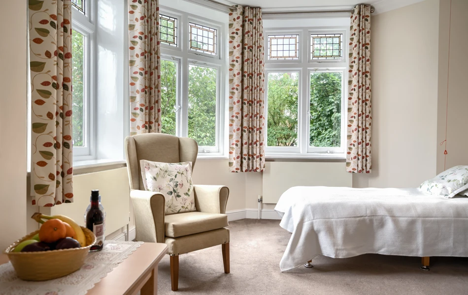 Bedroom with garden view through bay windows at Lee House Wimbledon