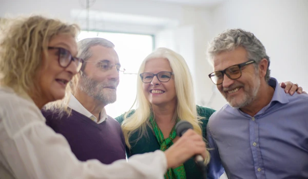 Group Of Older People Enjoying Karaoke Together