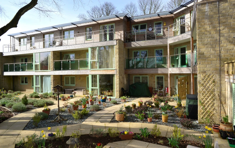 Outside garden area with bird table and colourful plants at Ing Royde,