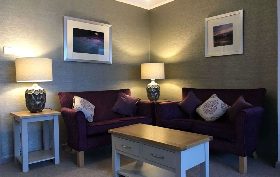 Cosy seating area with lamps and sofas