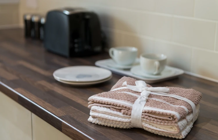 Tea towels and crockery on the kitchen side