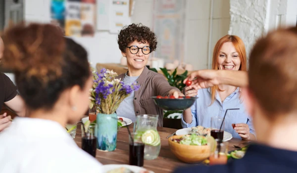 Group Of Happy People Enjoying A Meal Together
