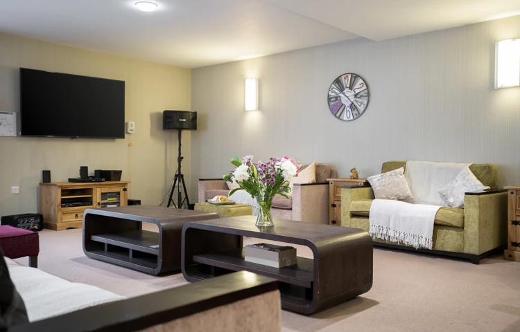 Communal resident lounge seating and tables at Hampton House