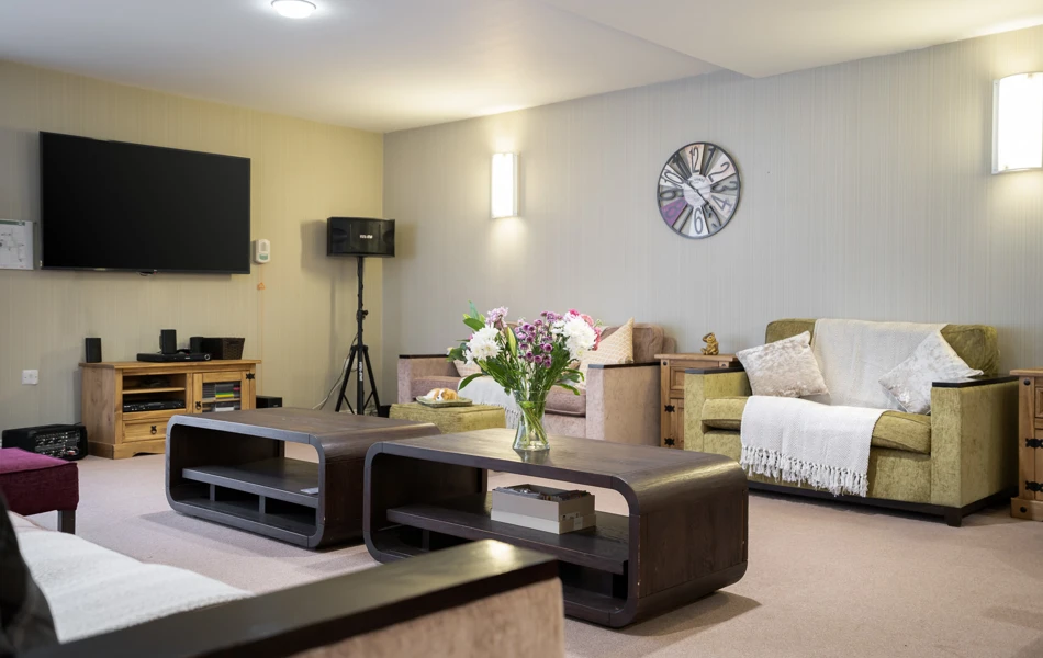 Communal resident lounge seating and tables at Hampton House